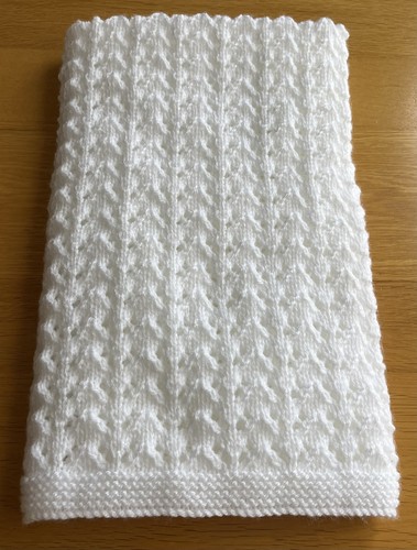 Hand knitted white baby - hand,