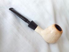 Meerschaum,  a creamy white, smooth apple bowled pipe