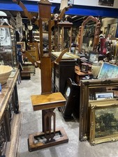 free-standing, antique wooden hall tree, also known as a coat rack or hat stand