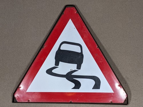 Slippery road warning sign - slippery,