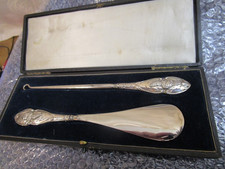 A Cased Silver Handled Button Hook and Shoe Horn. Birmingham 1905 or 1915