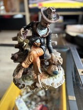 Vintage  Capodimonte tramp on bench Figure 9 1/2 inch long cx 11 inch tall