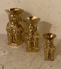 A vintage set of three graduated brass Toby jugs