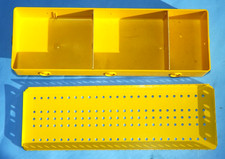 Meccano yellow plastic storage tray, with metal lid and card dividers.