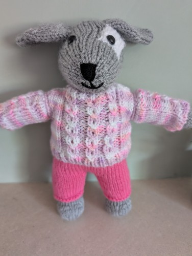 Hand knitted dog puppy in - hand,