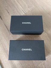 Two empty Chanel sunglasses boxes.