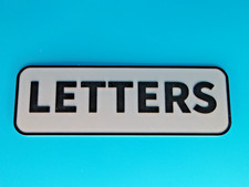 BLACK/SILVER LETTERS SIGN