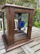 Antique mahogany counter display cabinet, showing Bombay Sapphire gin logo.