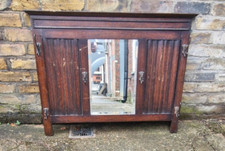 Antique wall mounted mahogany mirrored coat / cloak rack. Good condition.