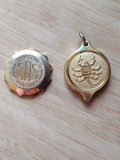 SOS Talisman gold tone pendant