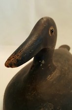 Vintage or antique carved wooden duck decoy model, brown duck with black bill. 