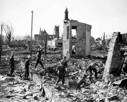 Soldiers pick through ruins