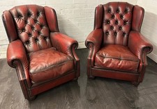 A pair of Tetrad Oskar leather chesterfield wing chairs in ox Blood Red