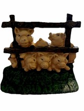 8"x7" cast iron door stop "Little Pigs" at the fence.
