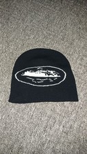 Black Cortiez Beanie With A White Cortiez Logo On The Beanie