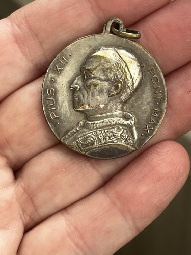 Religious medal featuring - religious,
