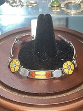 JAMES FENTON, AN ART NOUVEAU SILVER ENAMEL FLORAL BRACELET