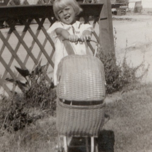C1930s girl pushing - girl, wicker