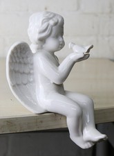 A Ceramic Sitting Angel or