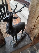 A Small Metal Ornament of A Stag with His Antlers On A Base