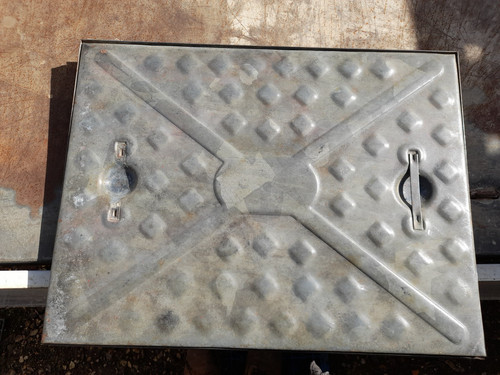 Galvanised metal manhole cover