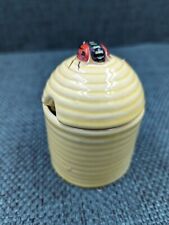 Vintage jam/honey pot with lid decorated with insects. In shape of skep/beehive