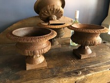 Four Rusty cast iron urns -