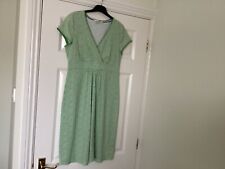 A Boden cap sleeved jersey dress in green with white dots