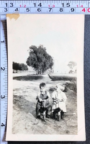 Two little children riding - two,