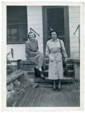 Two Women Posing Outside Front