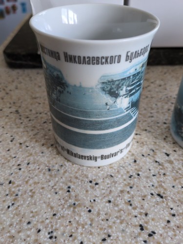 Four souvenir mugs from - four,
