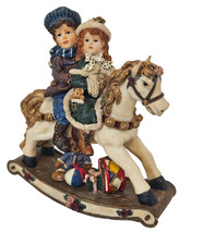 Two Childern Riding A Rocking