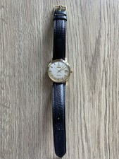 vintage goldcapped Omega Seamaster De Ville automatic with a linen-textured dial