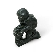Levi Qumaluk (Inuit, 1919-1997), soapstone carving of a man holding a seal