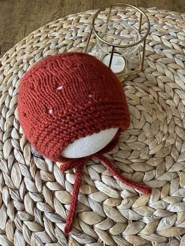 Hand knitted newborn bonnet - hand,