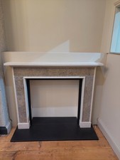 Chesneys limestone fireplace, hearth and slips in matt granite.