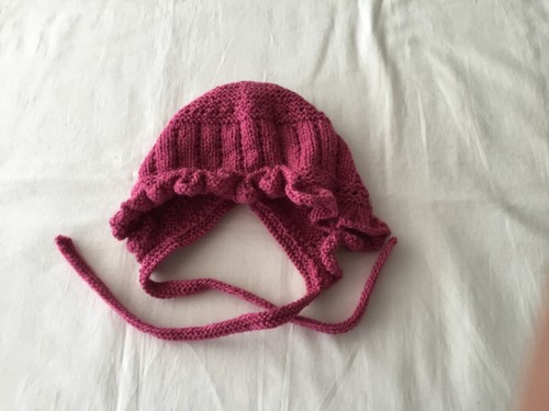 Hand knitted baby bonnet with - hand,