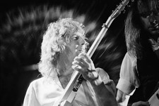 Rick Parfitt guitarist with Status Quo playing his guitar during a- Old Photo