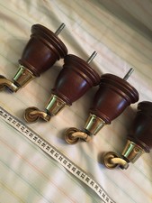 4 x ? oak dark wooden furniture / chair legs wih brass castors a set
