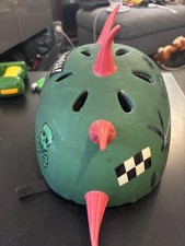Green Protective Helmet with Red Spikes and Graphic Decals