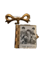Rare Beatles vintage brooch, containing 11 black and white photos of the Beatles