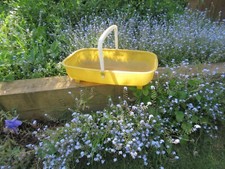 Vintage yellow plastic garden trug basket for prop display