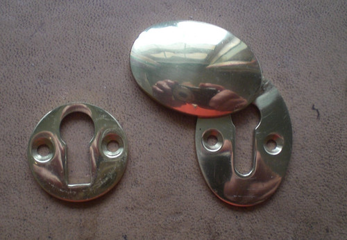 Two brass keyhole escutcheon