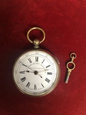 Brass chronograph pocket watch with key.  Excellent working condition