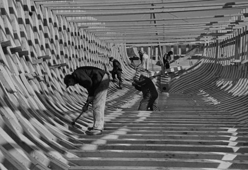 Group men working hull - , a