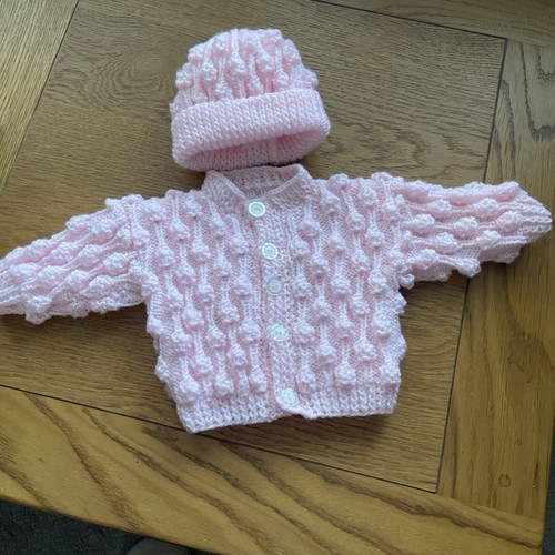 Hand knitted baby cardigan and - hand,