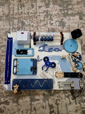 Montessori busy board featuring a dinosaur theme and the name "Leo"