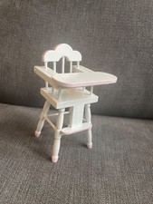 white and pink wooden dolls