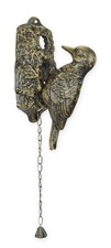 A cast iron woodpecker door
