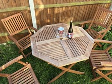 Hardly used octagonal wooden garden table and four chairs